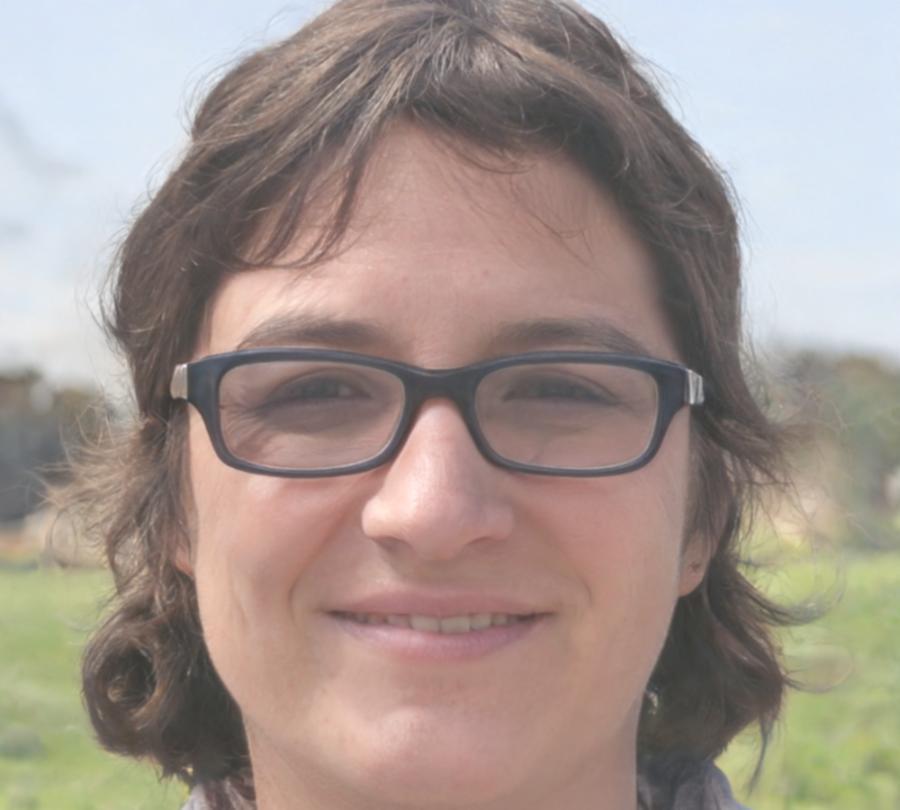 Professional headshot of team member in modern office environment